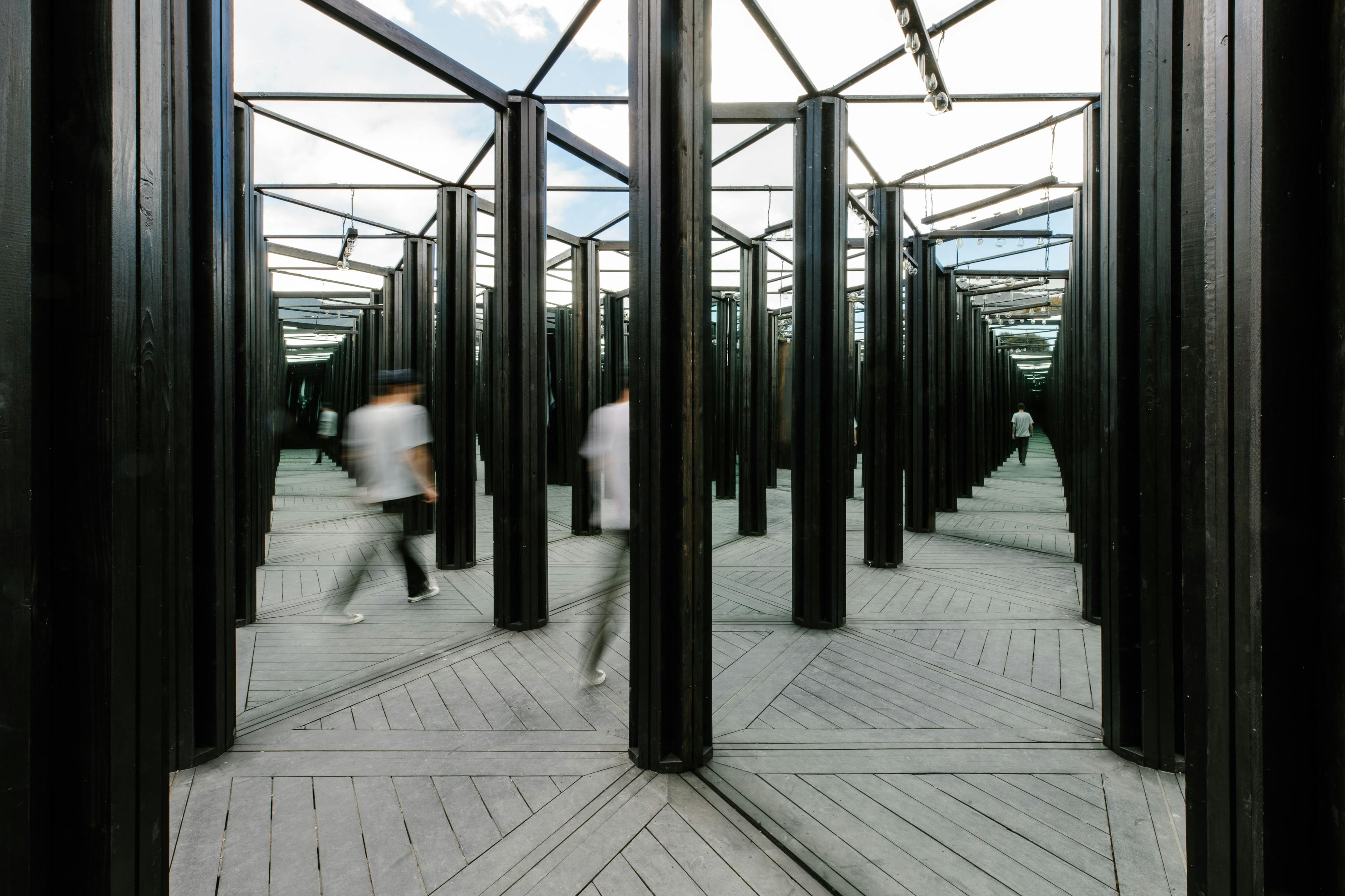 a man walking through the house of mirrors