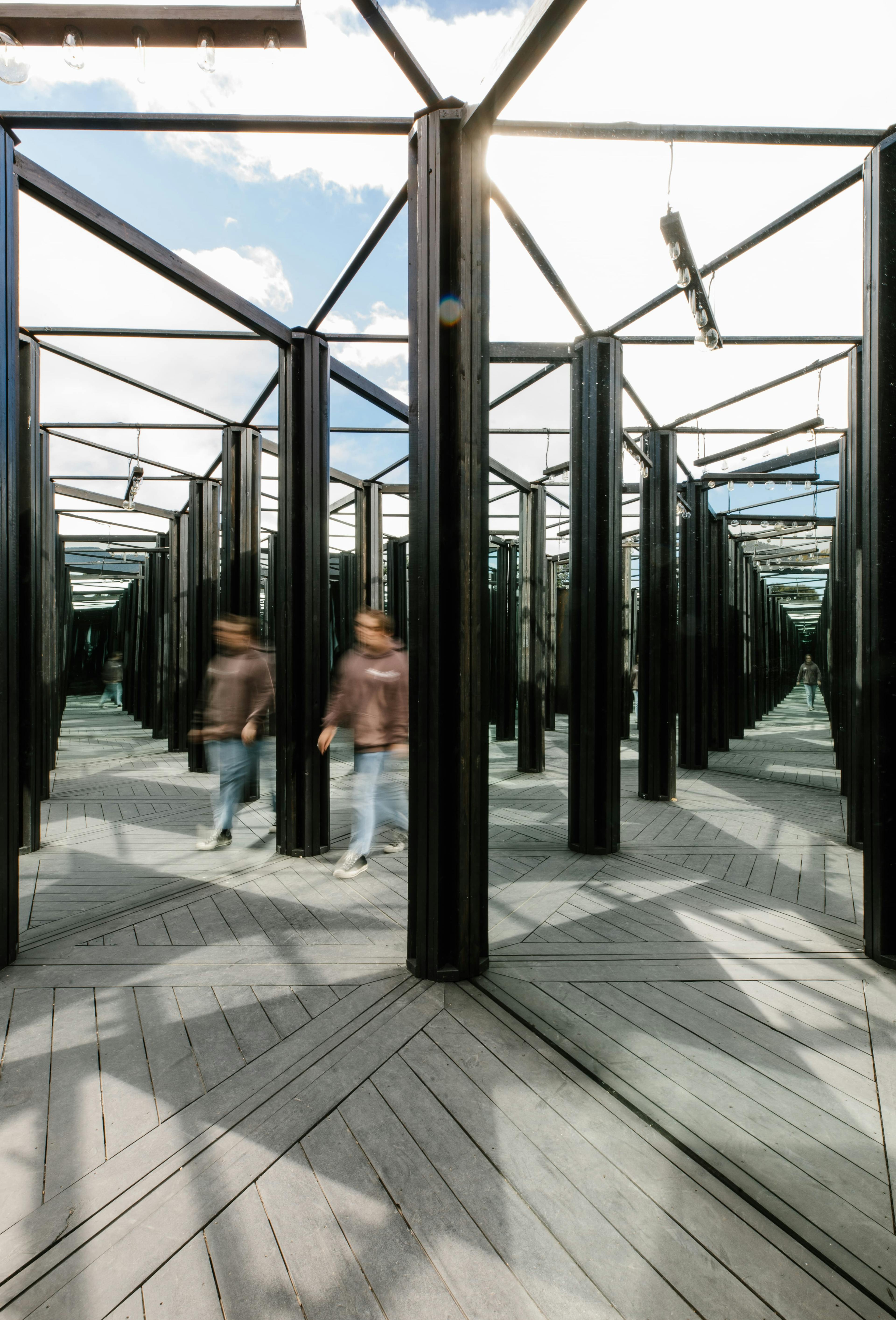 A person walking through the house of mirrors