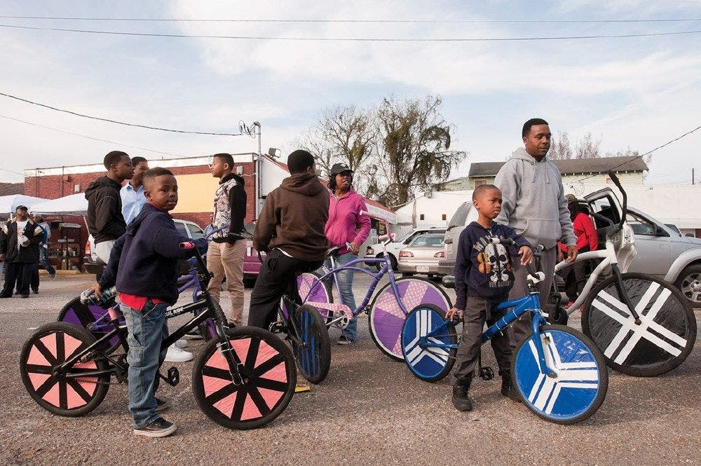 People with BMX bikes with tape decorating the tires and frames