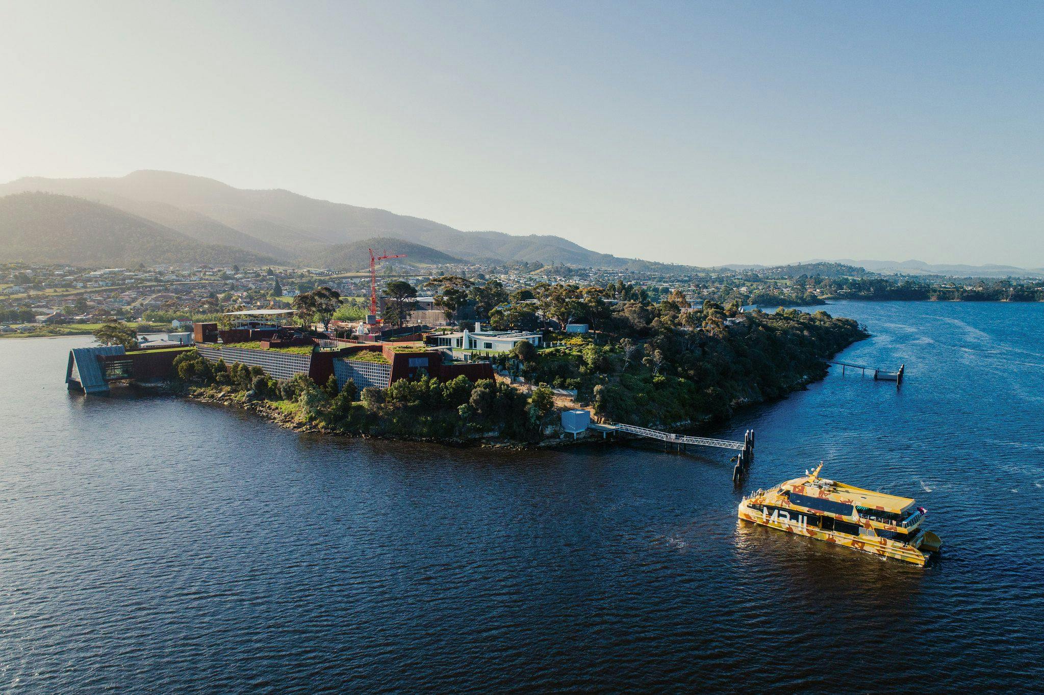 Aerial image of the ferry inbound to the Mona site