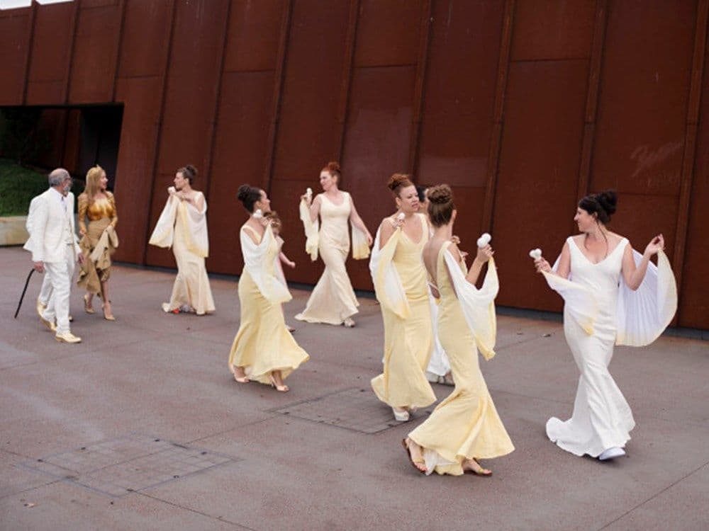 Bridal party of seven escorting Kirsha (bride) to the ceremony. Dresses all of a golden/yellow colour with shawls.
